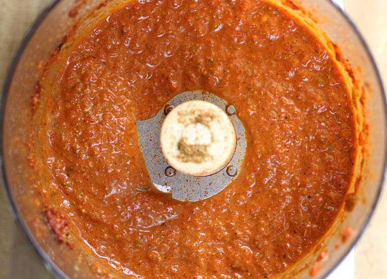 Smoother harissa paste in a food processor after oil has been added.