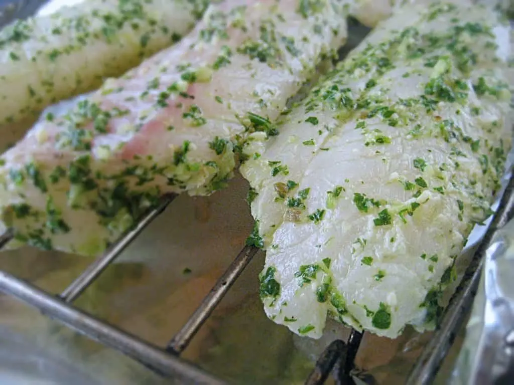 fish baking in the oven on a rack.