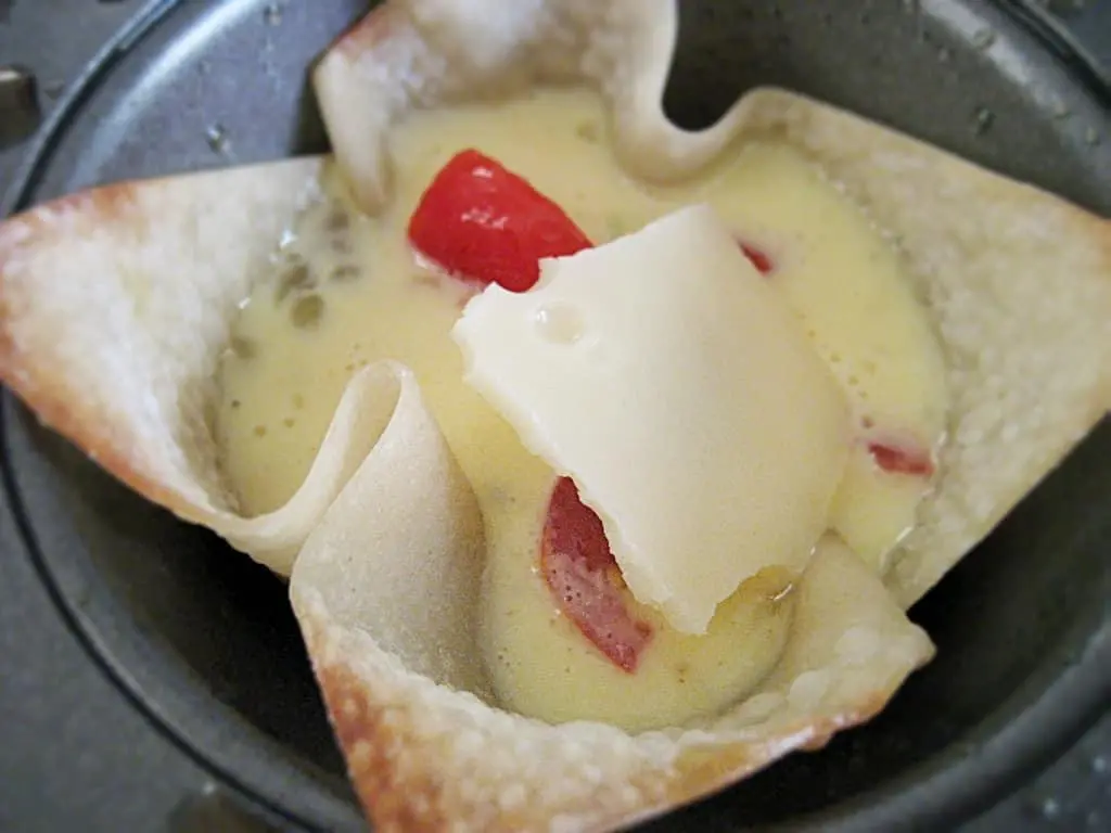 Pour egg mixture into wonton wrappers and bake.