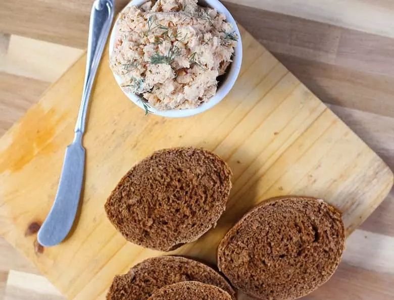 Rye bread, sliced with salmon pate in a bowl.