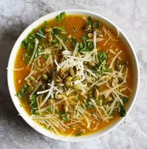 Orange & Ginger Pumpkin Soup with Miso. A light, healthy, vegetarian soup garnished with pepitas, parmesan and fresh herbs. This healthy recipe will satisfy without the guilt.