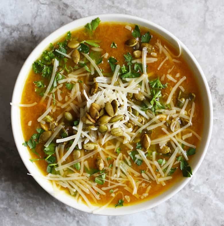 Orange & Ginger Pumpkin Soup with Miso. A light, healthy, vegetarian soup garnished with pepitas, parmesan and fresh herbs. This healthy recipe will satisfy without the guilt.
