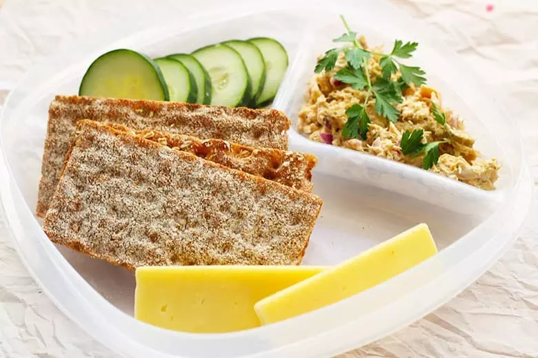 Healthy Scandinavian Lunch Meal Prep. An easy and healthy solution for a healthy new year. Salmon salad is served with nutritious crackers and veggie sides. Prepare lunches for the whole week without the guilt.