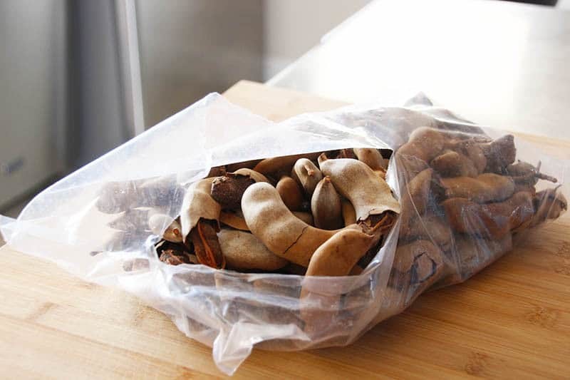 A bag of tamarind pods on the counter.