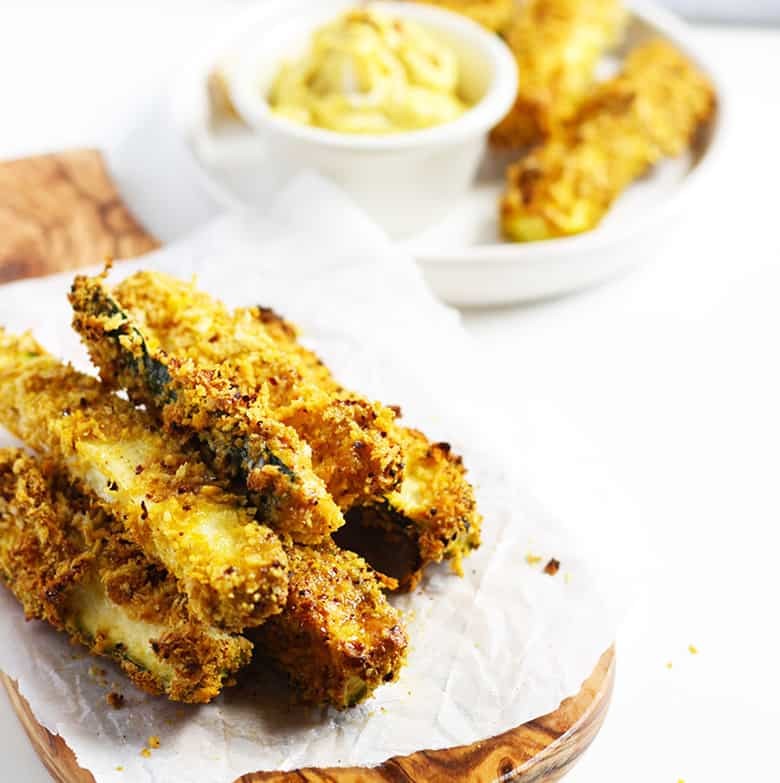 Baked zucchini fries on a cutting board.