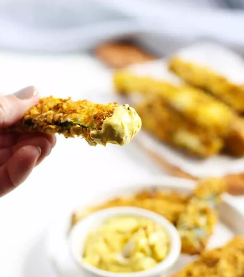 One baked zucchini fry dipped in curry fry sauce.