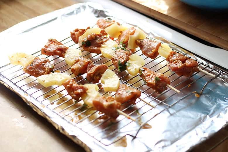 Skewers on a rimmed and lined baking sheet.