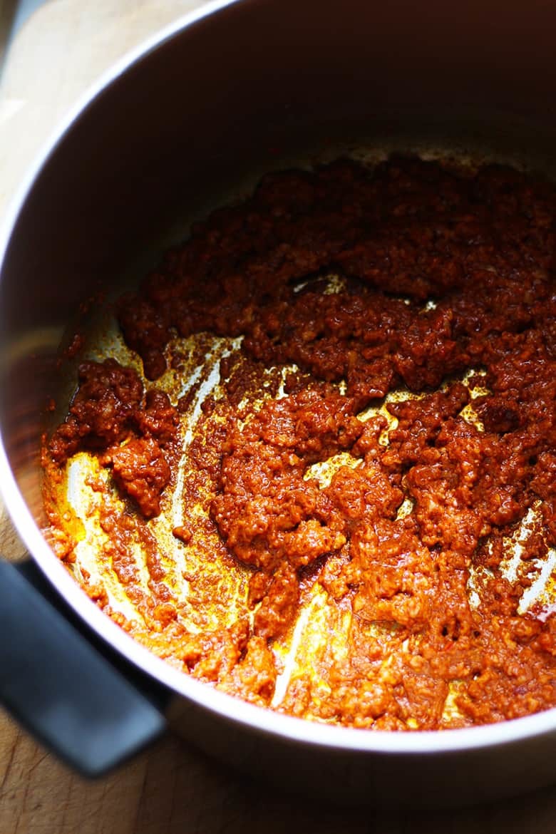 Chorizo cooking in a pan.