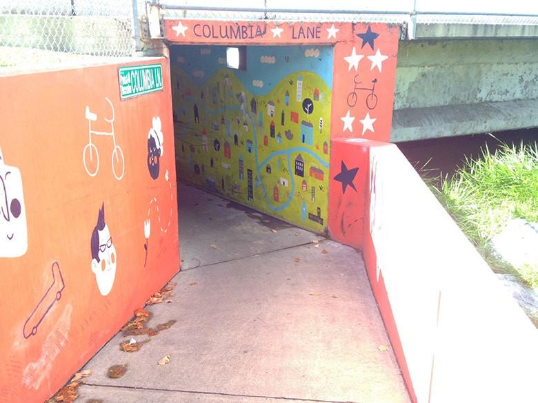 A tunnel painted in murals.