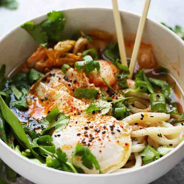 Kimchi Udon Noodle Soup, a quick and easy Korean meal. Udon noodles, kimchi, fried egg, spinach, sesame oil, fish sauce, chili oil, scallions, cilantro.