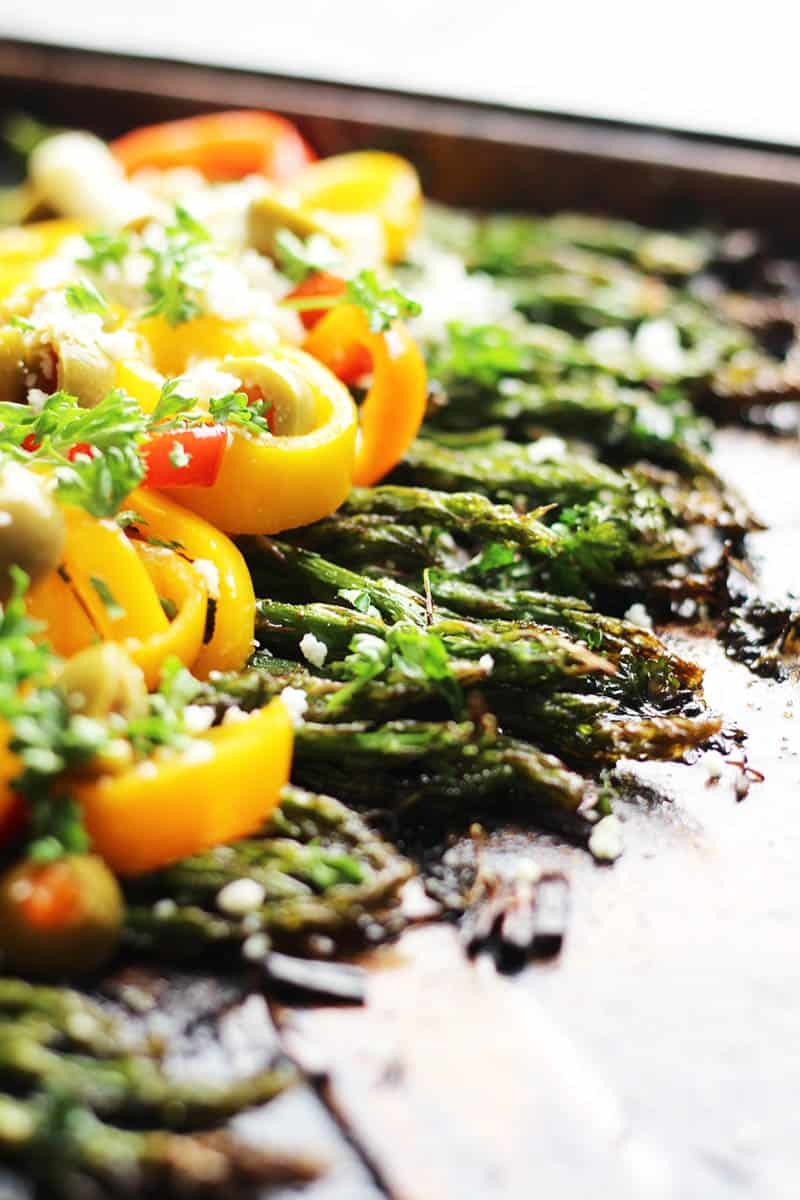 Roasted Spring Asparagus | with sweet peppers and feta. A Mediterranean inspired dish to welcome in Spring and Easter Sunday. Drizzled with olive oil, tossed with fresh herbs and garlic and garnished with sweet peppers and olives. Oh my YUM!!! | FusionCraftiness.com