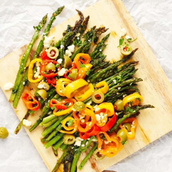 Roasted Spring Asparagus | with sweet peppers and feta. A Mediterranean inspired dish to welcome in Spring and Easter Sunday. Drizzled with olive oil, tossed with fresh herbs and garlic and garnished with sweet peppers and olives. Oh my YUM!!! | FusionCraftiness.com