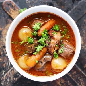 Boeuf Bourguignon | A classic French beef stew made easy. This easy beef stew develops its flavor from many layers, onions, mushrooms, carrots, bacon, beef, red wine, broth, garlic, bay leaf and thyme.