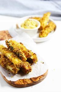 Baked zucchini fries on a cutting board.
