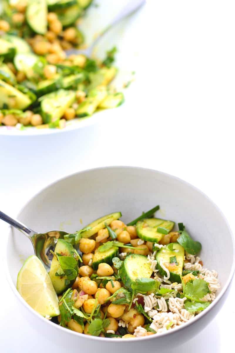 Chickpea and cucumber salad in a white bowl.