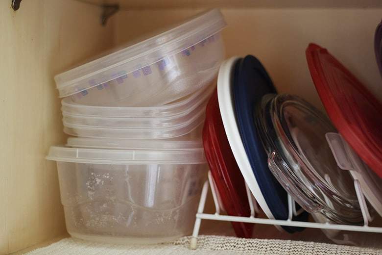 Stacked food containers and lids.
