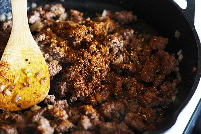 A pan with cooked ground beef with spices.