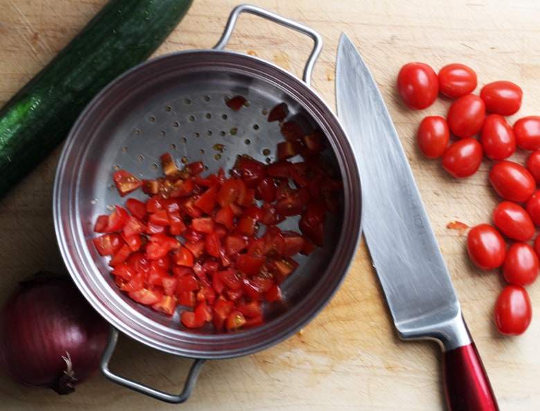 Chopped tomatoes in a sieve.