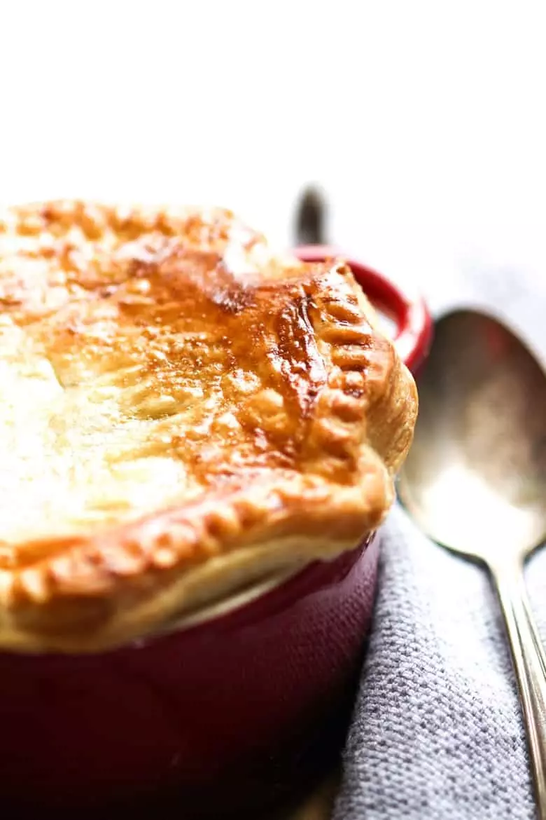 Beef and Guinness Pie in a ramekins with a golden crust of puff pastry.