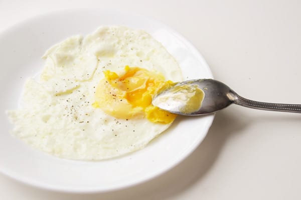 Over Medium Egg on a white plate.