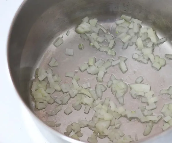 Onions sautéing in soup pot.