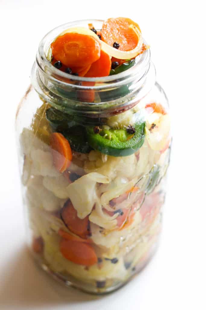 A jar full of vegetables.