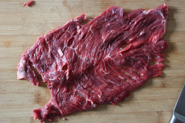 Flap meat on a cutting board.