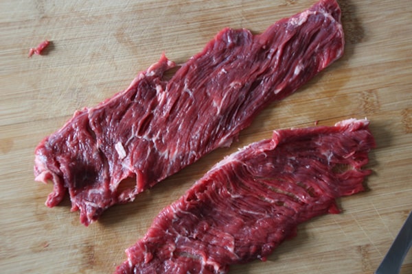Flap meat on a cutting board.