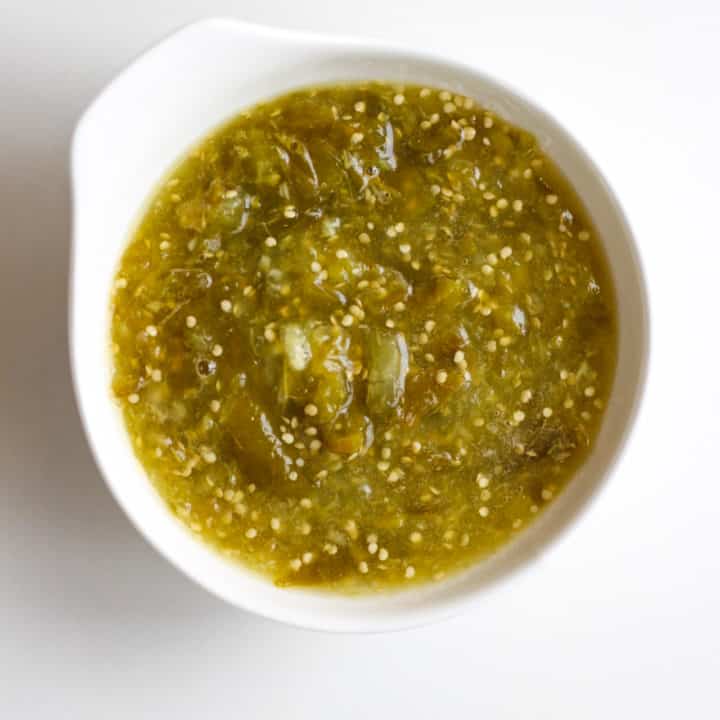 A bowl of green salsa.