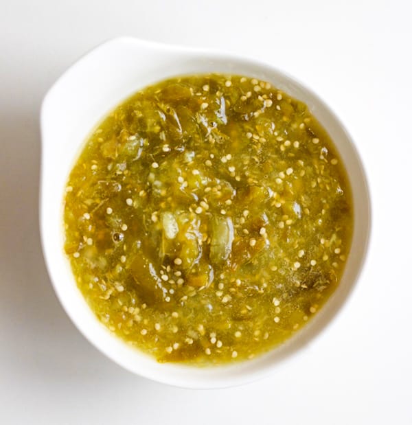 A bowl of green salsa.