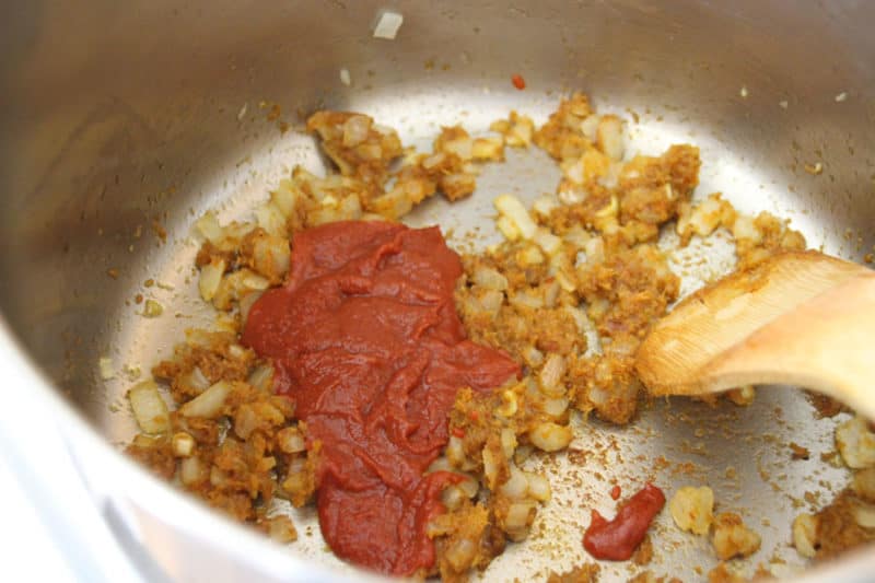 Onions and Curry Paste in a pan with tomato paste.