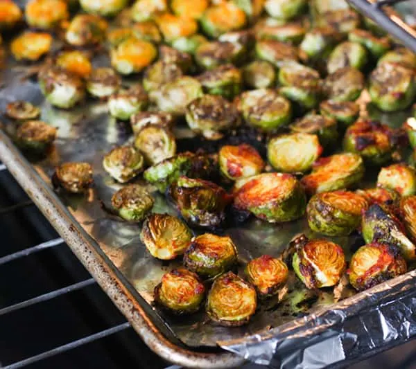 Brussels sprouts halves with marinade brushed on.