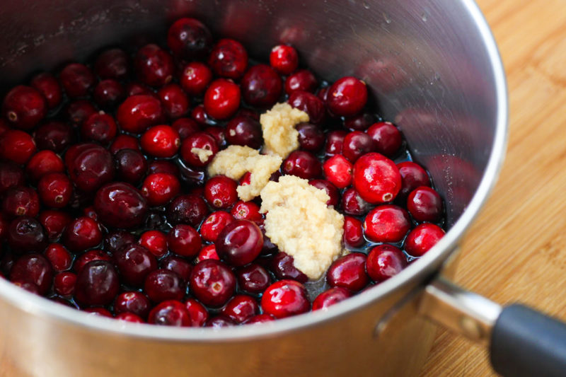 Cranberries and ginger in a pan.