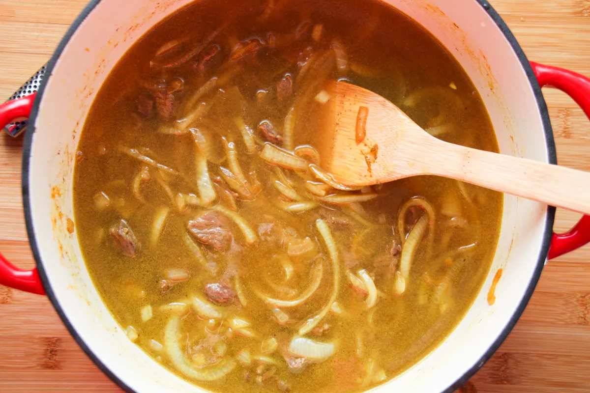 Onions and meat cooking in broth.