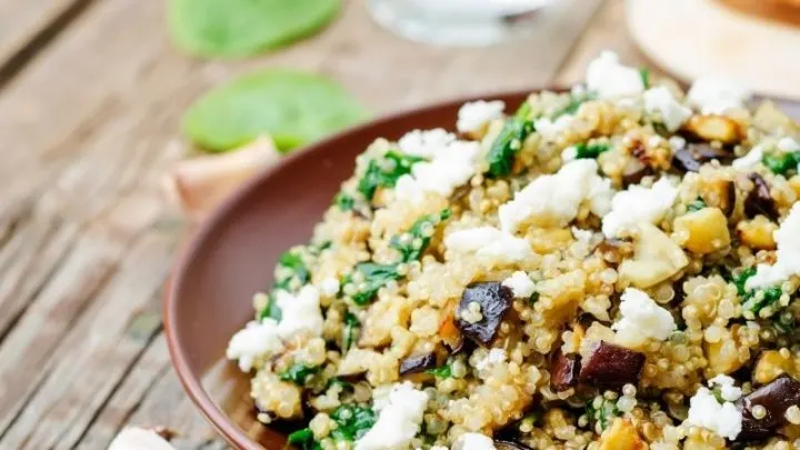 Quinoa salad with feta cheese, spinach and olives.