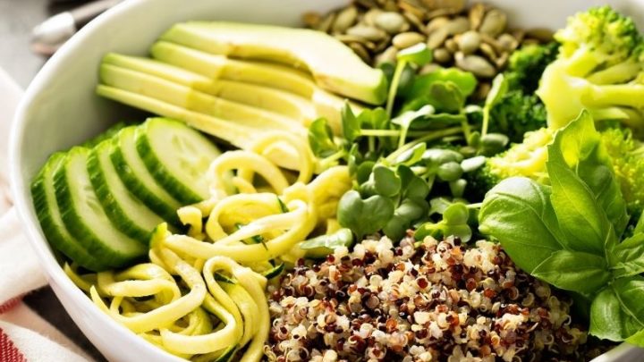 Quinoa veggie bowl with avocado, cucumber, zucchini, pea shoots and pepitas.