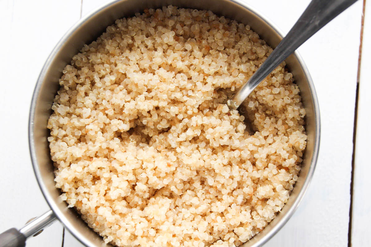 Cooked quinoa in a small pan.