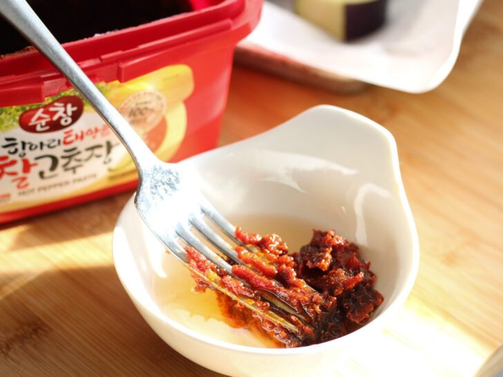 Gochujang in a small bowl with water.