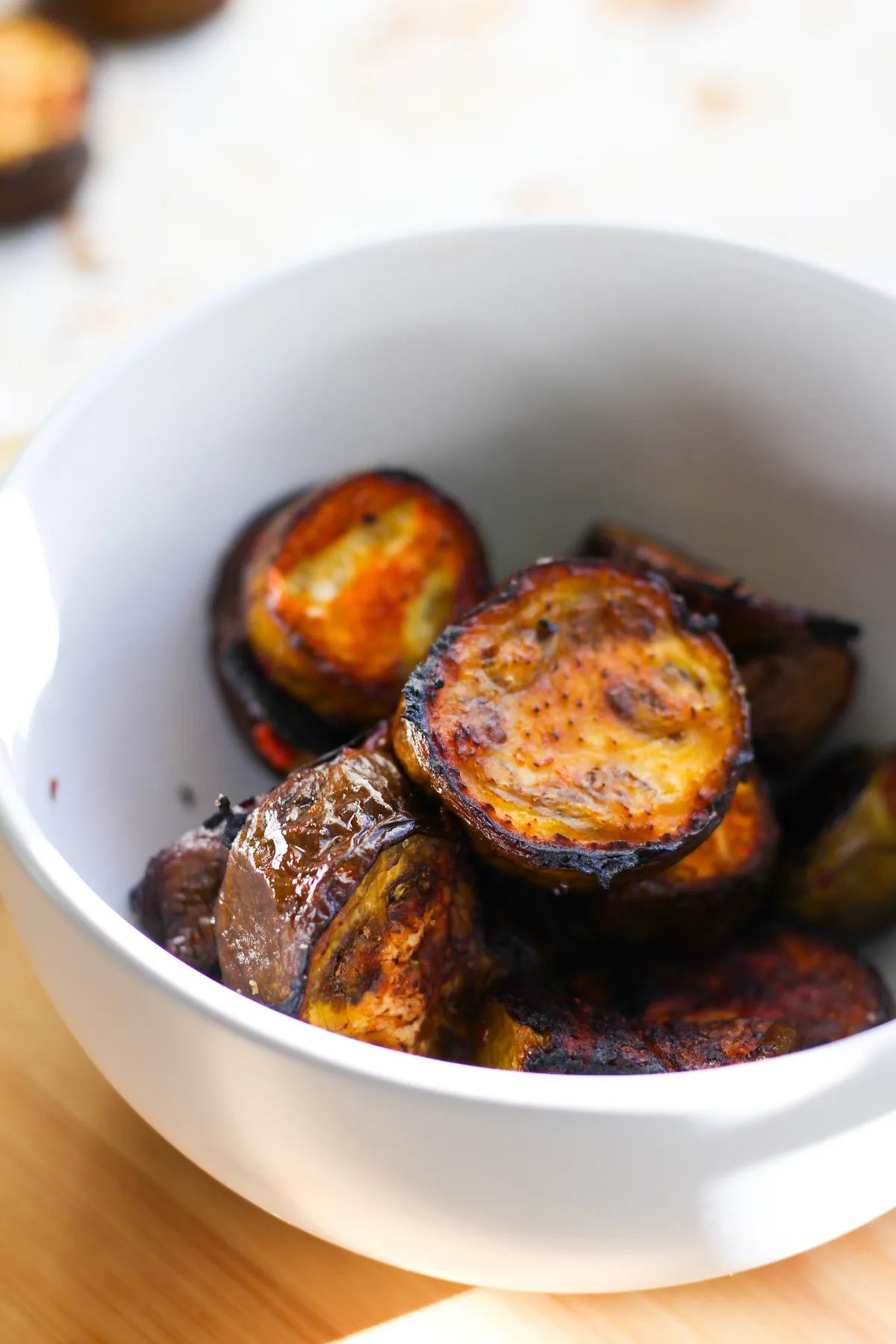Roasted eggplant slices in a bowl.